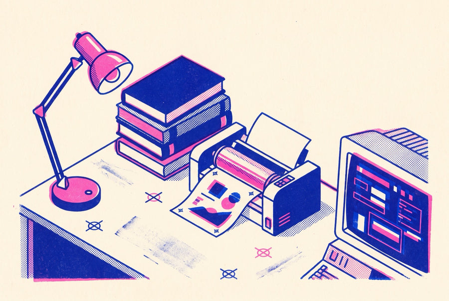 The para-academic desk: books, a terminal, a risograph mid-feed